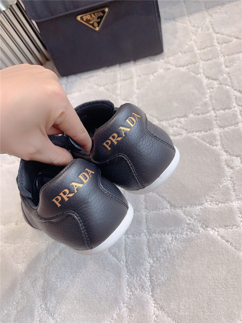 Pra*a triangle logo sneakers in black