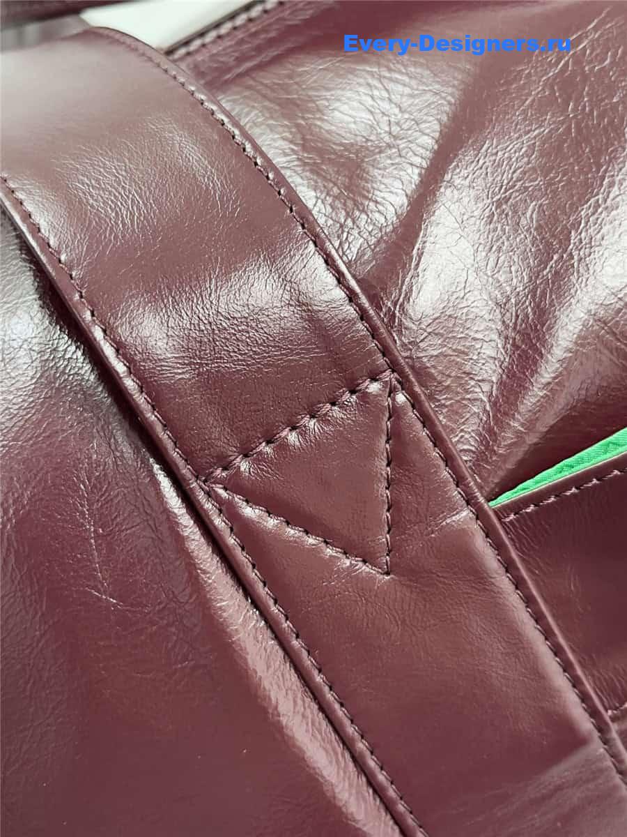 b0tt*ga Ven*ta wine red leather travel bag